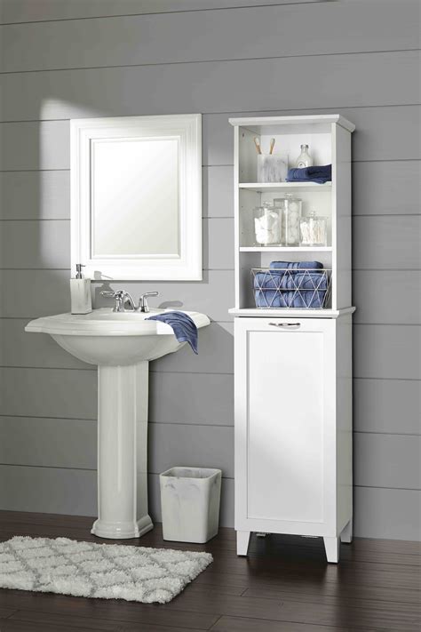 bathroom cabinet with laundry hamper.